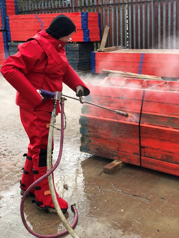 Trainee learning how to clean formwork.